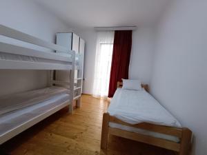 a bedroom with two bunk beds and a window at Ivan Apartment Skopje in Skopje