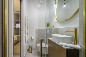 a bathroom with a sink and a toilet and a mirror at Antique Spalato Luxury Rooms in Split +37 photos