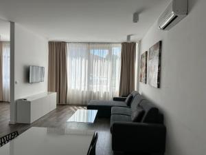 a living room with a couch and a tv at Hotel Kapitol in Most