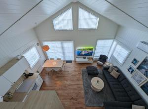 an overhead view of a living room with a couch and a tv at Lovely home by Glomma river! in Vidnes