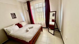 a small bedroom with a bed with a window at Rorot 1 bedroom annex Eldoret,Arlene in Eldoret
