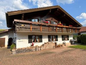 a large white building with windows and a balcony at Landhaus Anne in Obermaiselstein