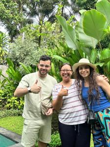a group of three people giving the thumbs up at Sawitri Anandhita Luxury Villas in Ubud