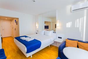 a bedroom with a large bed and a mirror at Orbi City on the Beach in Batumi