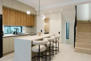 a kitchen with a counter and bar stools at Destino Residencies in Loutraki