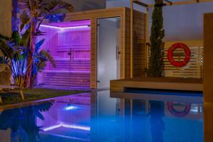 a house with a swimming pool with purple lights at 1935 Hotel Boutique by Terraza in Roses