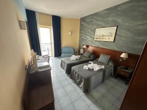 Postel nebo postele na pokoji v ubytování Grand Hotel L'Approdo