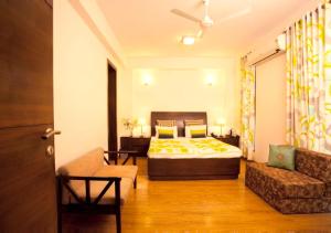 a hotel room with a bed and a couch at Perch Service Apartment- Sector 40 in Gurgaon +22 photos
