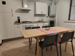 a kitchen with a table and chairs with a tablecloth on it at Host4ALL Bixio Cuore di Falconara in Falconara Marittima