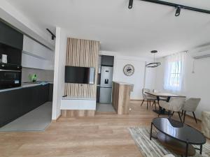 a living room with a kitchen and a dining room at Apartman Petra in Niš +8 photos