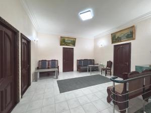 a room with two doors and a table and chairs at Hotel AVE in Yerevan