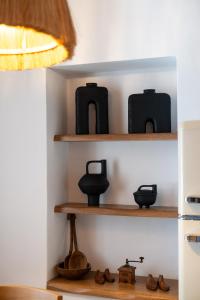 a shelf with vases and other items on it at Villa Antonis in Halki