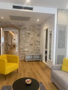a living room with a couch and a table at Priuli Luxury Rooms in Split