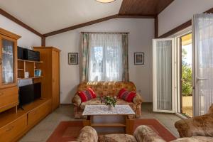 a living room with a couch and a table at Beachfront House Nada - Happy Rentals in Karlobag