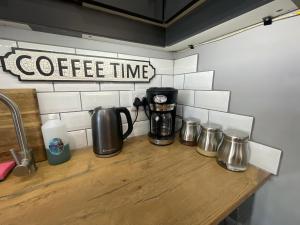 a counter with a coffee maker on a counter top at PINE COTTAGE Self catering fully equipped 2 bedroom, Queen bed 3 singles 65sqm cosy private cottage in Durban