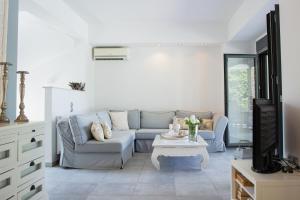 a living room with a couch and a table at Serenity Villa in Sani in Sani Beach