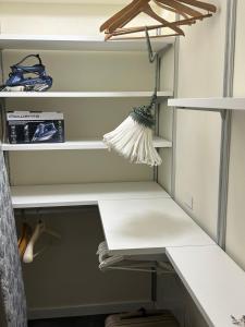 a closet with white shelves and a desk at Varenna Guest House in Varenna