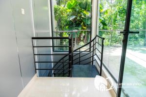 a staircase in a house with a window at Damansara Heights by Plush in Kuala Lumpur