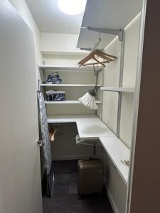a walk in closet with a desk and shelves at Varenna Guest House in Varenna