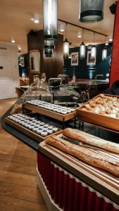 a bakery with many different types of breads and pastries at Maison Mère in Paris