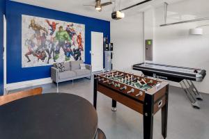 a living room with a foosball table and a piano at 8BR Luxury - Sleeps 22 - Near Disney with Pool & Hot Tub! in Davenport