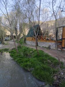 a view of a river with a building in the background at Fio's Garden camping otel in Aksaray