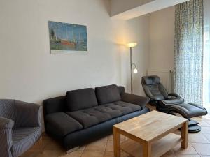 a living room with a couch and a chair at Gabi mit Pool und Sauna in Übersee