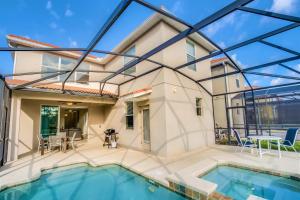 a view of a house with a swimming pool at Near Disney - 5BR Home- Games Pool Hot Tub & BBQ in Kissimmee