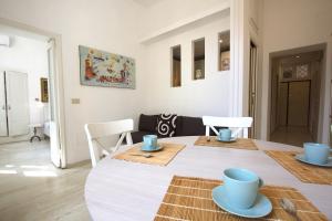 a dining room with a table with blue cups and plates at Testaccio View Holiday House in Rome