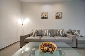 a living room with a couch and a bowl on a table at Sliema 2 Bedroom close to seafront in Sliema