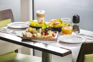 a table with a tray of food on it at Patak Park Hotel Visegr&aacute;d in Visegr&aacute;d