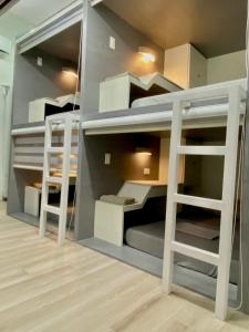 a room with two bunk beds with a ladder at Otravel Hostel 5 minutes from Mactan Airport in Pusok