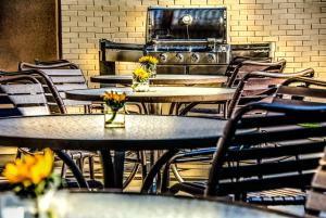 a row of tables and chairs with flowers on them at Hyatt House Herndon/Reston in Herndon