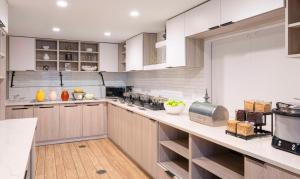 a large kitchen with wooden cabinets and a counter top at Hyatt House Herndon/Reston in Herndon