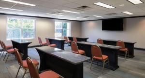 Sala de conferencias con mesas, sillas y TV en Hyatt House Herndon/Reston en Herndon