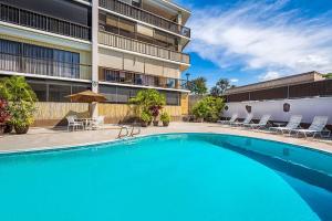 a swimming pool in front of a building at Kona Plaza#203 in Kailua-Kona