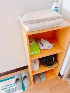 a small wooden shelf with a shelf at ひまわりHotel in Nagasaki