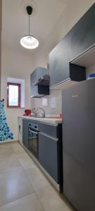 a kitchen with stainless steel appliances in a room at Palazzo Sandù Dimora nel Borgo in San Nicola Arcella +24 photos