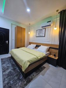 a bedroom with a large bed in a room at Genesis Grid Homes - Ibiza Edition in Lagos +5 photos