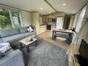 a living room with a couch and a table at Robin Hood Caravan Park in York