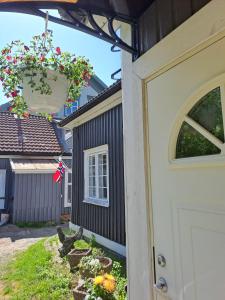a front door of a house with a flower pot at George&K Apartament in Larvik