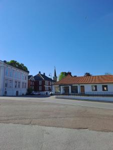 an empty street in a town with buildings at George&K Apartament in Larvik