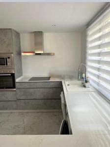 a kitchen with a sink and a counter top at La Manga Club Resort - 3 bedroom Duplex - La Colina in Atamaría