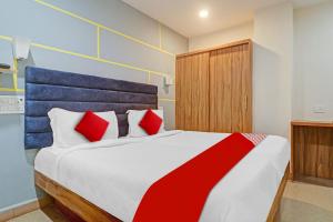 a bedroom with a large bed with red pillows at OYO Flagship Luxury Rooms in Hyderabad