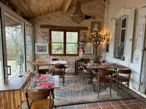 a dining room with tables and chairs in a house at Domaine Lapin Qui Rit , chambre Céline in Saint-Jean-de-Côle