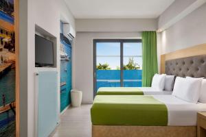 A television and/or entertainment centre at TRYP by Wyndham Corfu Dassia