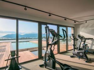 a gym with a view of a swimming pool at ibis Styles Porto Vecchio in Porto-Vecchio