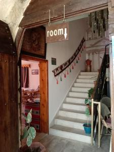 a room with stairs and a sign that reads room at Petra fort hotel in Wadi Musa