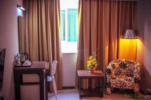 Postel nebo postele na pokoji v ubytování Ritz Garden Hotel Manjung
