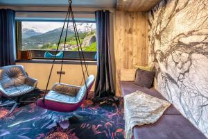 a room with two chairs and a swing at HEART - Manufaktur Appartements in Sölden